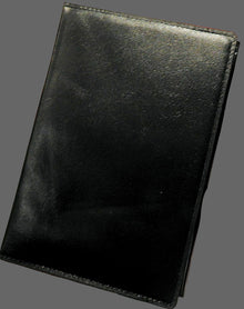 Hand holding a black leather wallet with a logo in the corner.