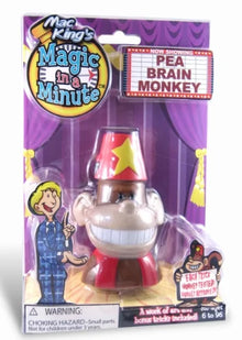 Toy figure of a monkey with a star on its head in packaging labeled 'Magic in a Minute'.