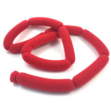 Red foam noodles on a white background