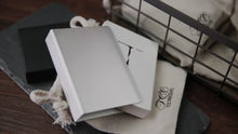 Stack of white cards with a logo on a textured surface