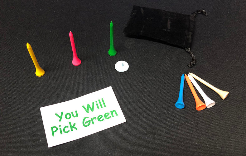 Colorful golf tees with a black drawstring bag on a dark surface.