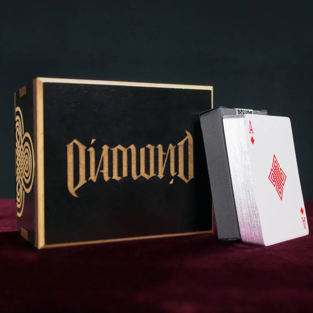 Diamond playing card box with a deck of cards on a dark background
