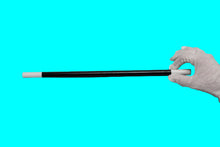 Hand holding a black and white rod against a gray background