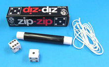 Magic trick set with dice, black cylindrical rod, and 'diz-diz' box on a blue background
