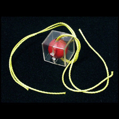 Red ball in a transparent cube with yellow string on a black background