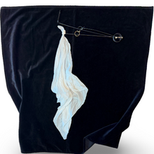 Black fabric with a white abstract design on a white background