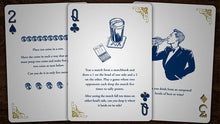 Two playing cards with blue designs and text on a wooden surface