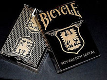 Bicycle Sovereign Metal playing cards with gold and black design on a dark background