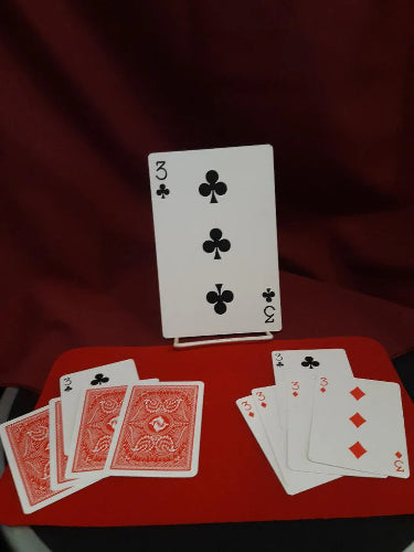 Playing cards on a red surface with a dark background