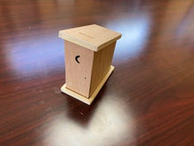 Wooden birdhouse on a wooden surface