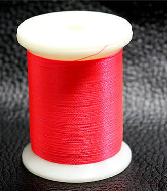 Red spool of thread on a black textured background with 'MJM Magic' branding.