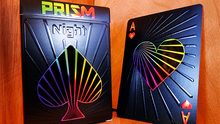 Two playing card packs with Prism Night design on a wooden surface