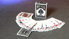 Bicycle playing cards with a deck of cards fanned out on a gray surface