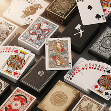 Collection of playing cards and card boxes on a dark surface