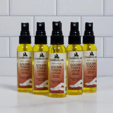Five bottles of Chamberlain Golden Touch Lotion on a white surface with a tiled wall background.