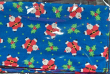 Blue fabric with Santa Claus and holly pattern