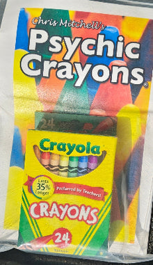 Crayola crayon set with 'Psychic Crayons' packaging in a car cup holder.