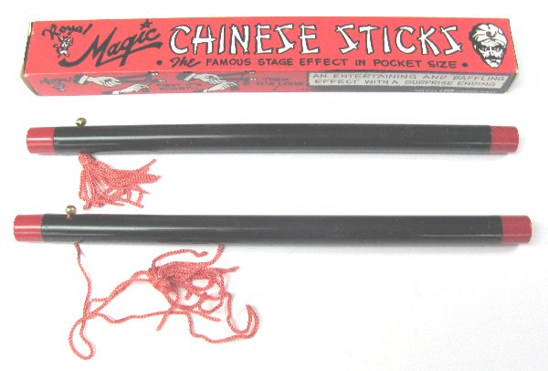 Two Chinese sticks with red string and their packaging on a white background