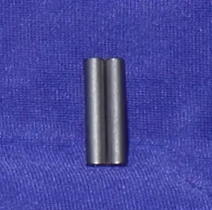 Two cylindrical metal parts on a blue fabric background