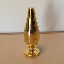 Gold decorative object on a beige surface with a white background