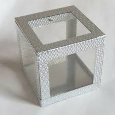 Square glass table with decorative silver border on a white background