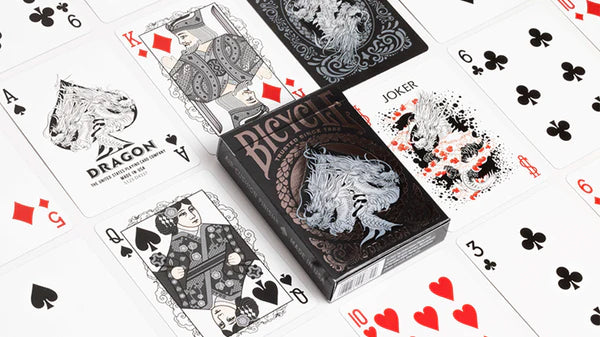 Black and white playing cards with visible branding on a white background