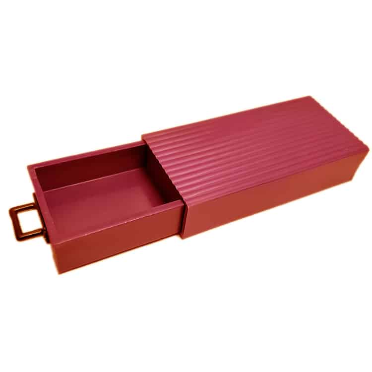 Red metal box with a textured lid on a white background
