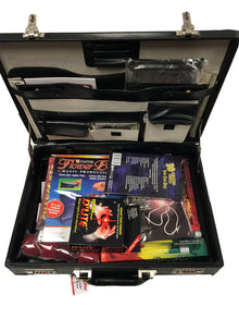 Black briefcase with compartments containing magic product packaging on a white background