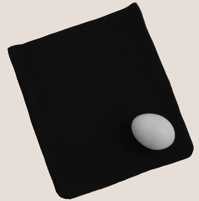 Black mouse pad with a gray sphere on a beige background