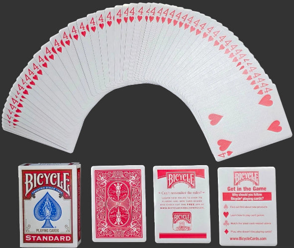 Bicycle playing cards fanned out with packaging and cards displayed below on a dark background