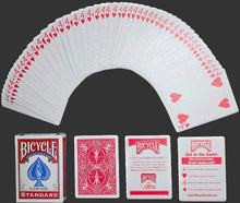 Bicycle playing cards fanned out with packaging and cards displayed below on a dark background
