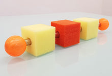 Colorful foam dumbbells on a reflective surface