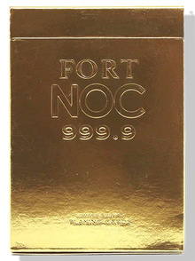 Gold foil card holder with 'FORT NOC 999.9' embossed text on a white background