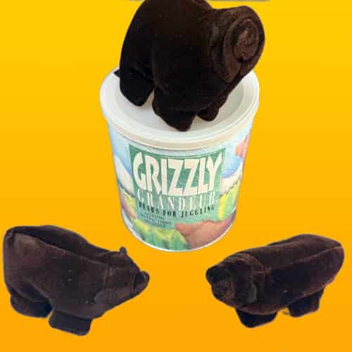 Plush bear toys with a container labeled 'Grizzly' on a yellow background