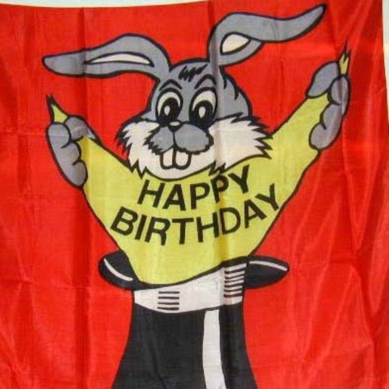 Cartoon character holding a banana with 'Happy Birthday' text on a red background