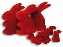 Red felt bunny shapes on a white background