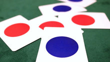 Card game with red and blue circles on a green surface