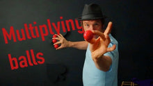 Person juggling red balls with text 'Multiplying balls' on a black background