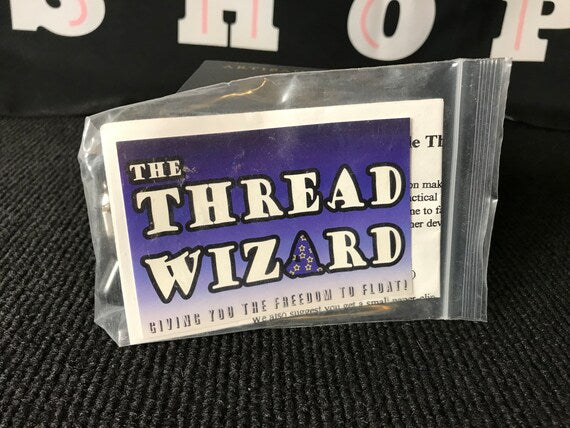 Packaged product labeled 'The Thread Wizard' on a black background