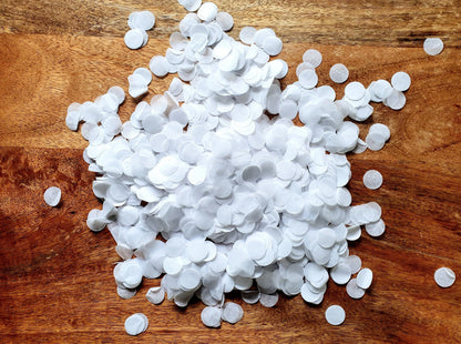 White round candies scattered on a wooden surface