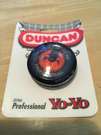 Duncan yo-yo on a branded card with a wooden surface background