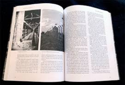 Open book with black and white photographs and text on a dark background