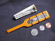 Film strip with slides of a dollar bill and coins on a dark background