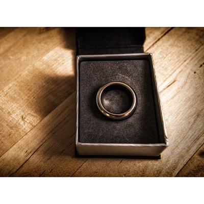 Bronze ring in a box on a wooden surface