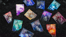 Collection of Bicycle branded playing cards with various designs on a dark background