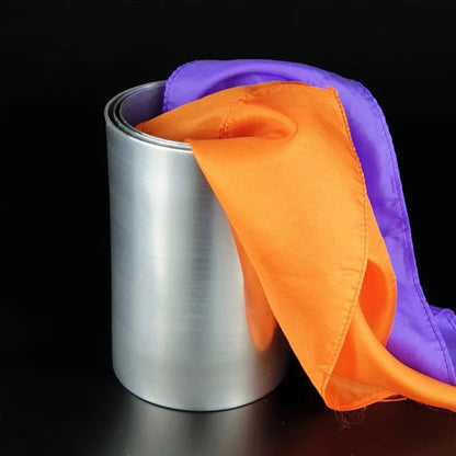 Silver container with a purple and orange cloth on a black background