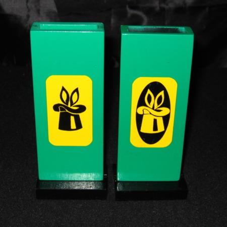 Two green rectangular blocks with yellow symbols on a black background