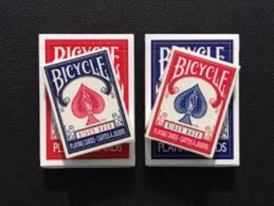 Two decks of Bicycle playing cards on a black background