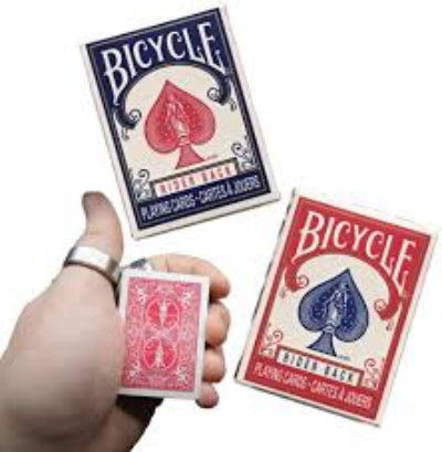 Three Bicycle playing cards held by a hand, with visible brand logos.