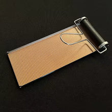 Grid roller with brown surface and metal handle on a black background